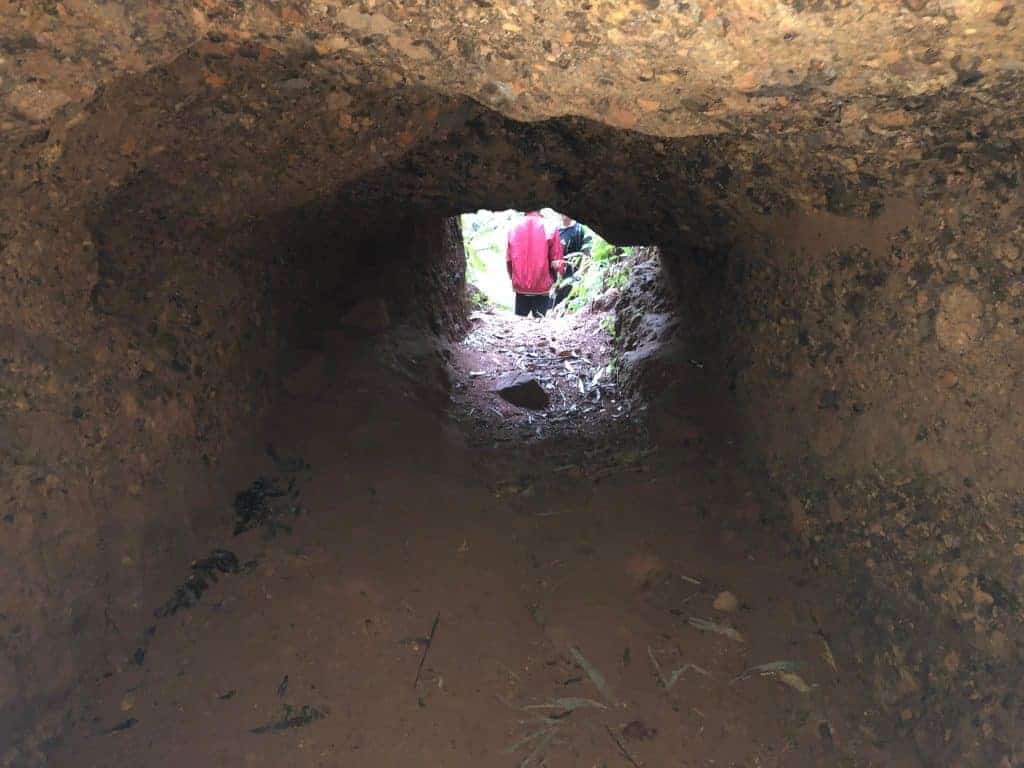 standing-inside-an-nva-tunnel-ho-chi-minh-trail-laos-xepon-area-looking-out-the-entrance